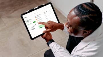 Dandy doctor using application on tablet